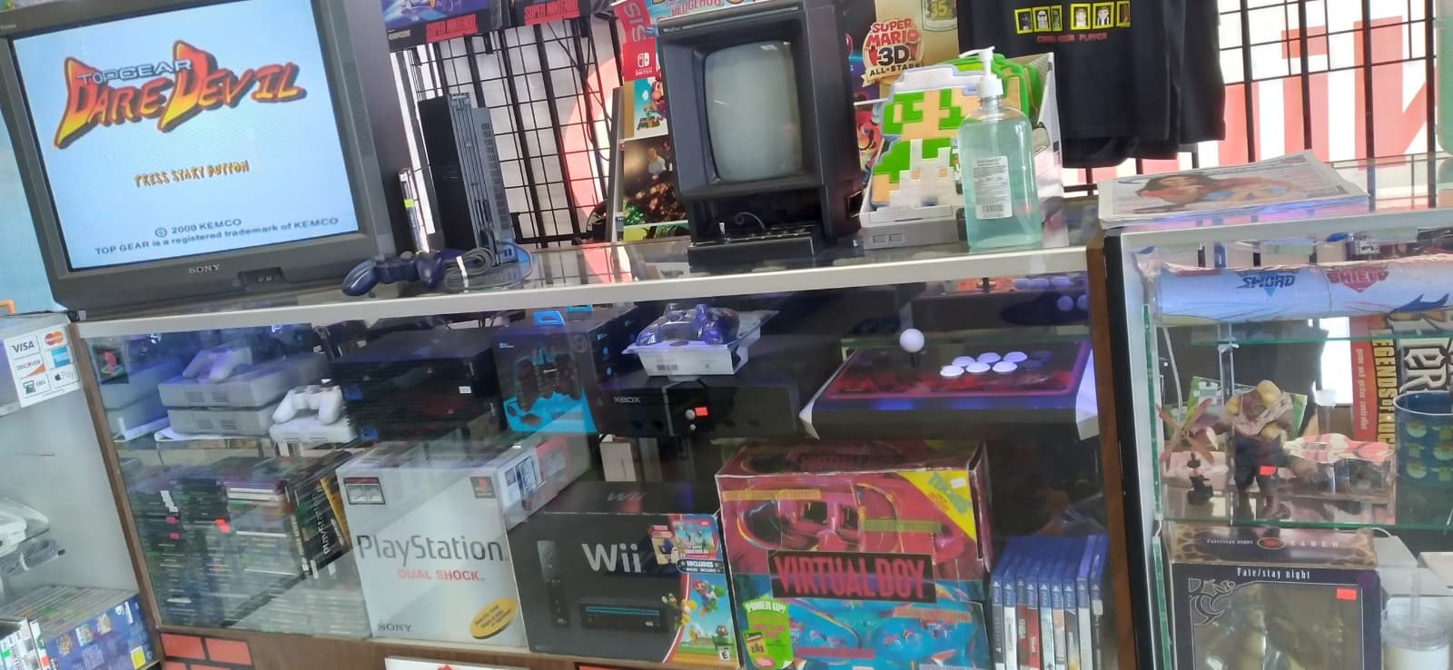 Store display case with boxed consoles and controllers